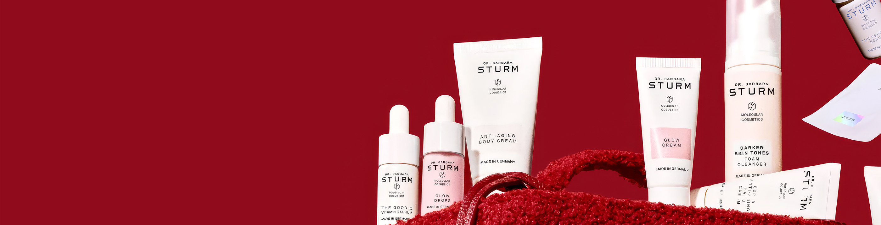 Various skincare products arranged on a red background.
