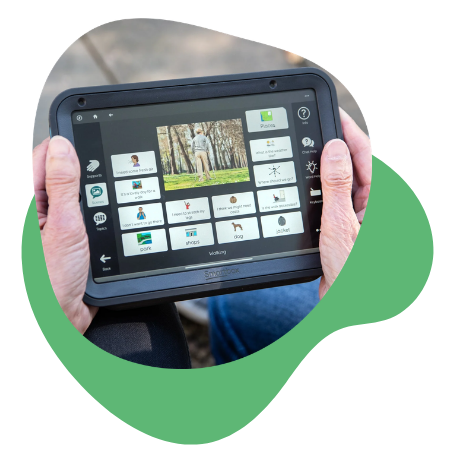 Person holding a Talk Pad AAC device displaying Aphasia Duo software.