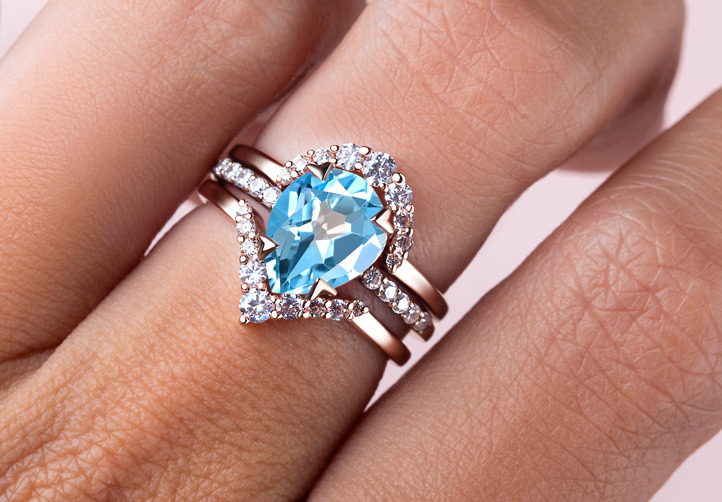 A hand shot of the bundle with Blue Topaz Ring - Nymph, Circle Band and Manifest Band. 