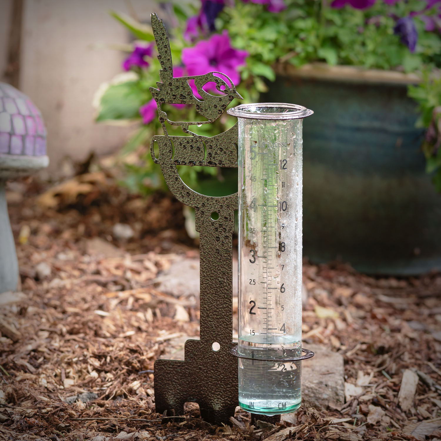 704-98937 decorative shovel and bird rain gauge in a garden setting.
