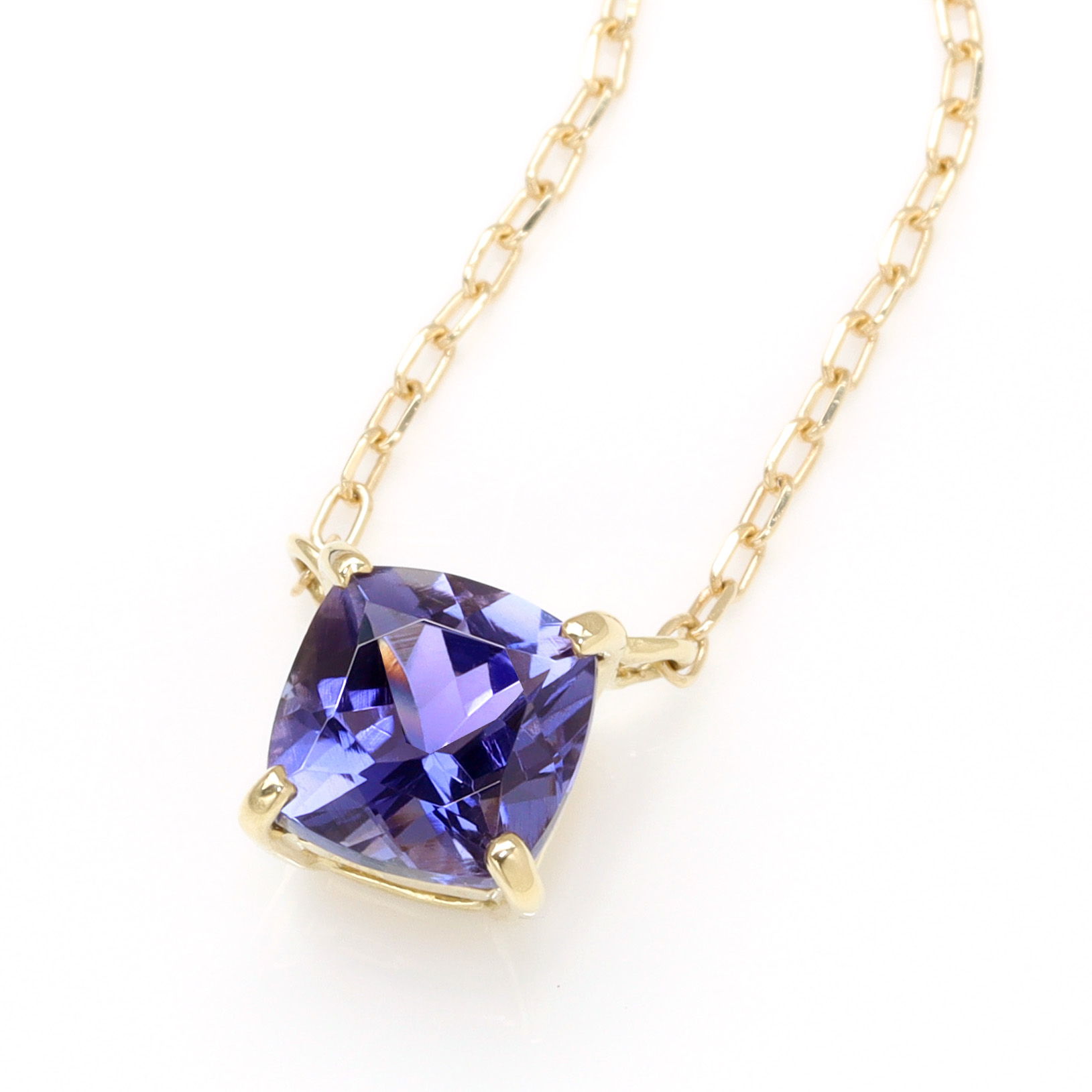 Gold necklace with a purple gemstone pendant.