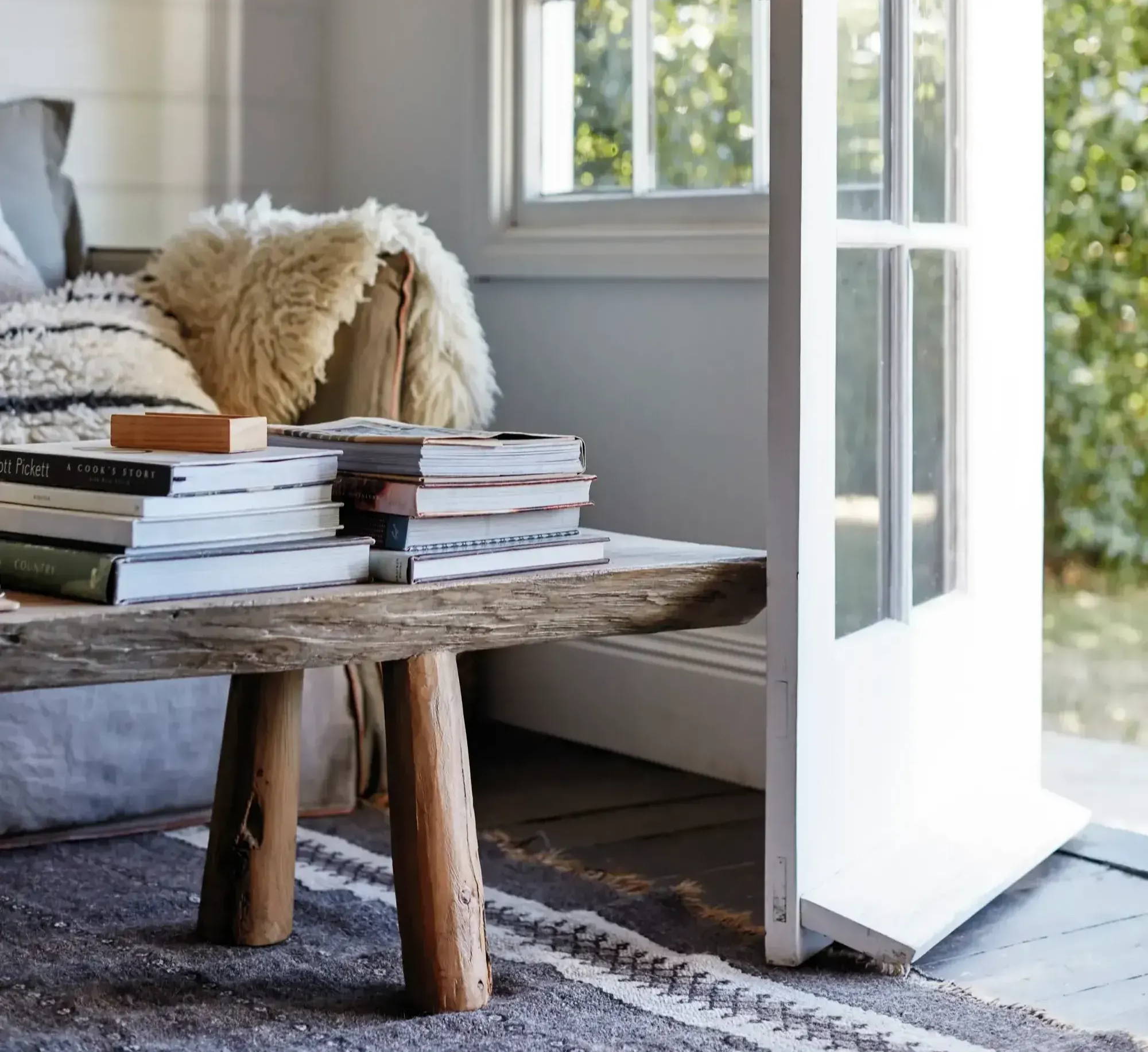 Books placed on top of a wooden table.