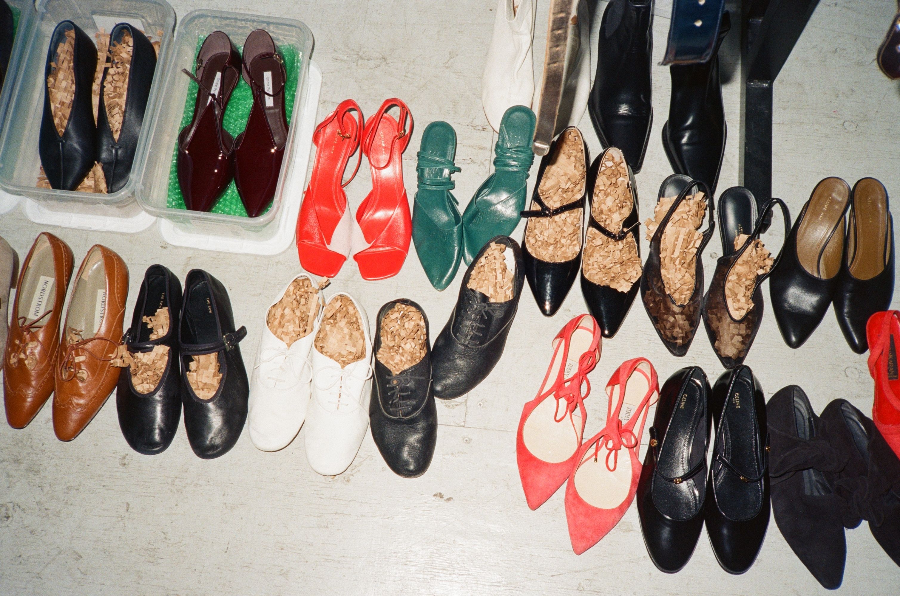 A variety of shoes arranged on a flat surface.