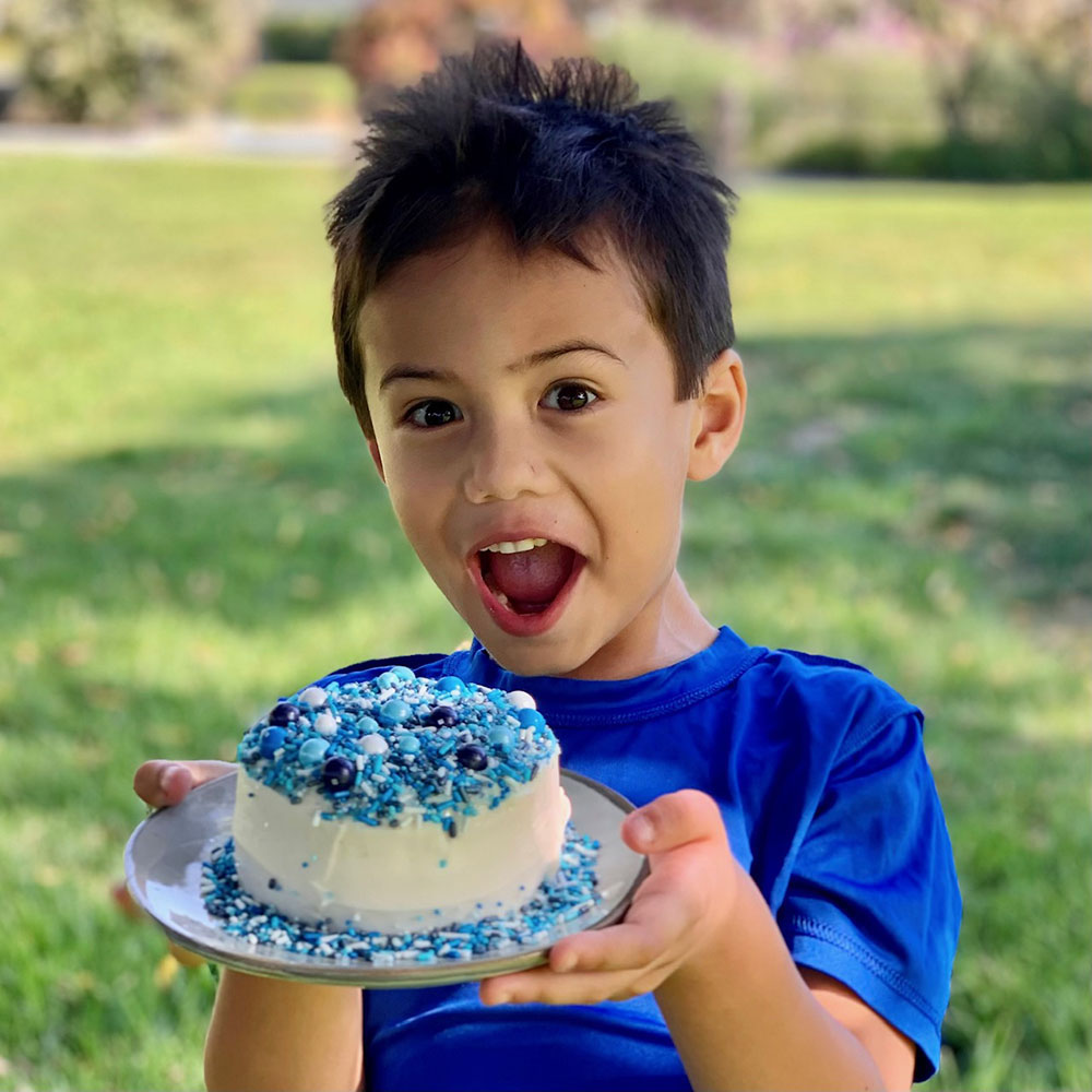 Image of child holding cake