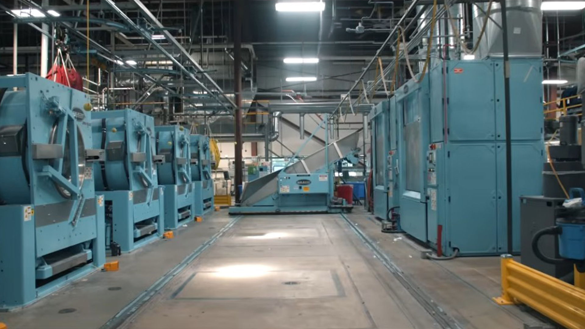 Industrial machinery lined up in a large factory setting.