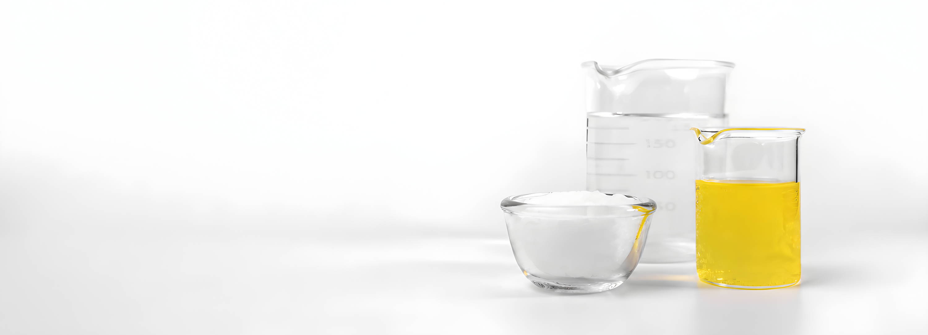 Three containers: one with yellow liquid, one with clear liquid, one empty.