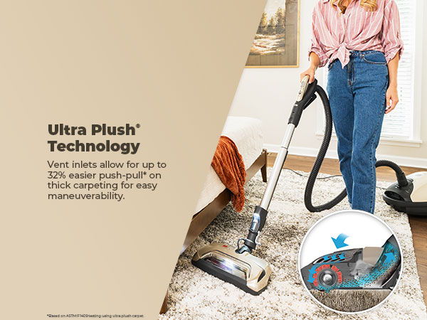 Person using a vacuum cleaner with Ultra Plush technology on a carpet.