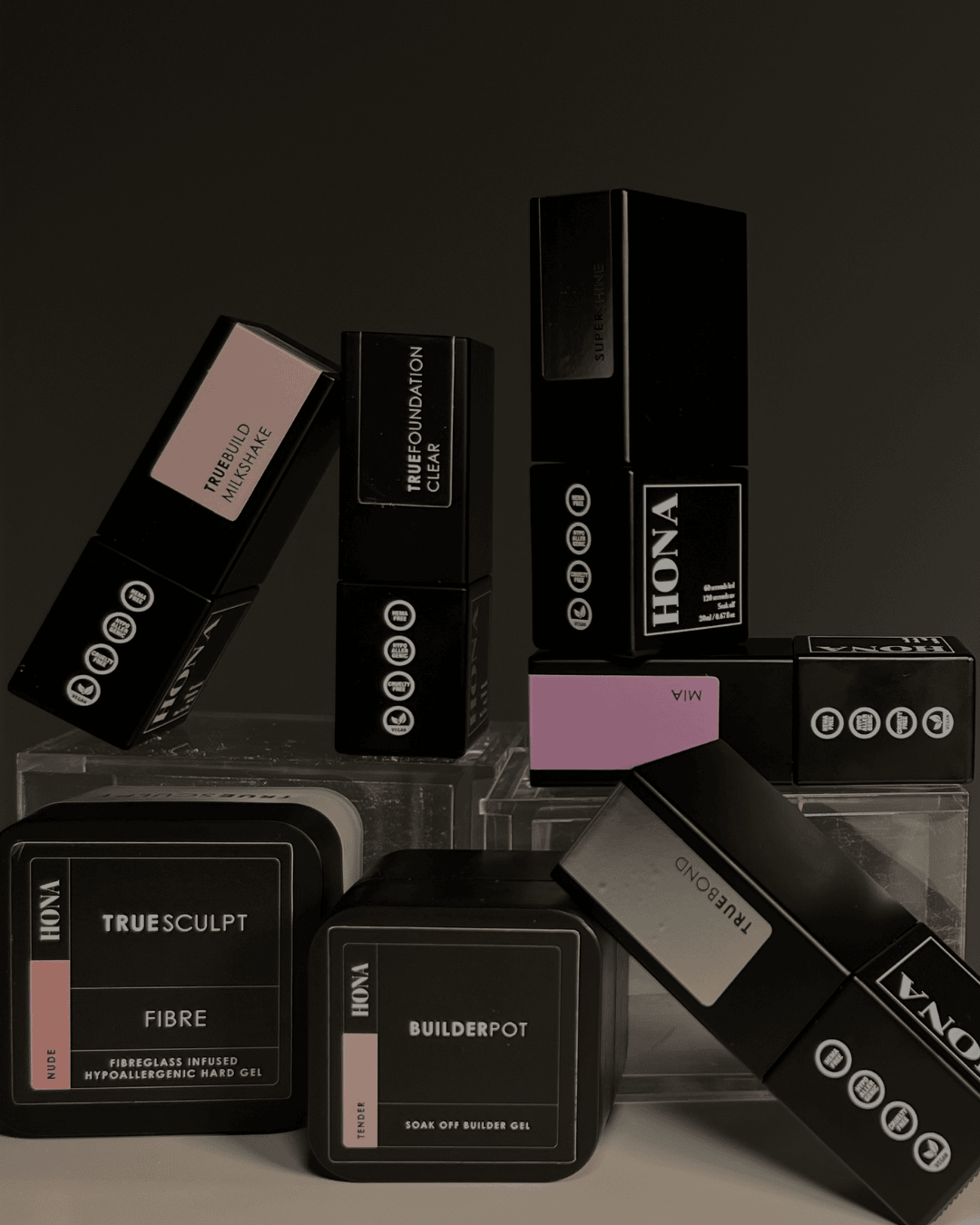 Various cosmetic product containers arranged stylishly against a dark background.