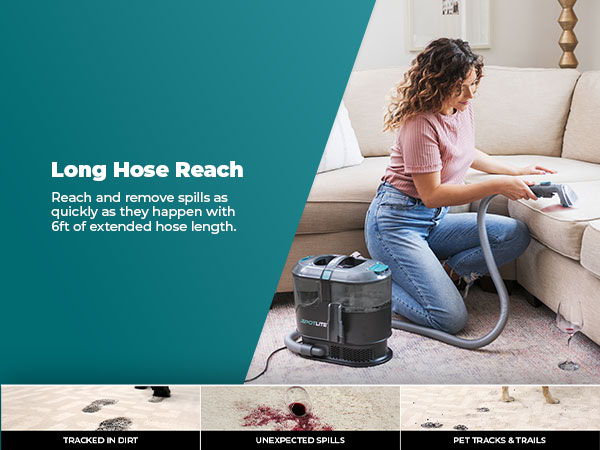 A person vacuuming a couch with a vacuum cleaner.