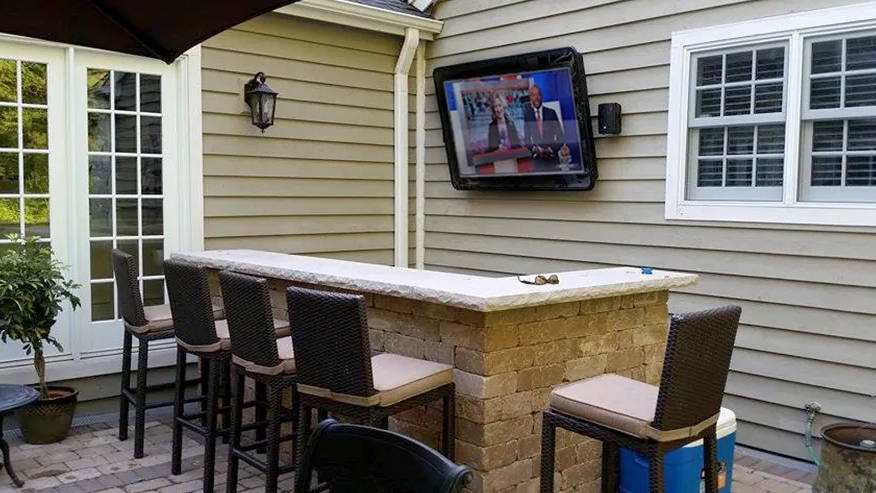 Weatherproof TV screen protection by outdoor bar