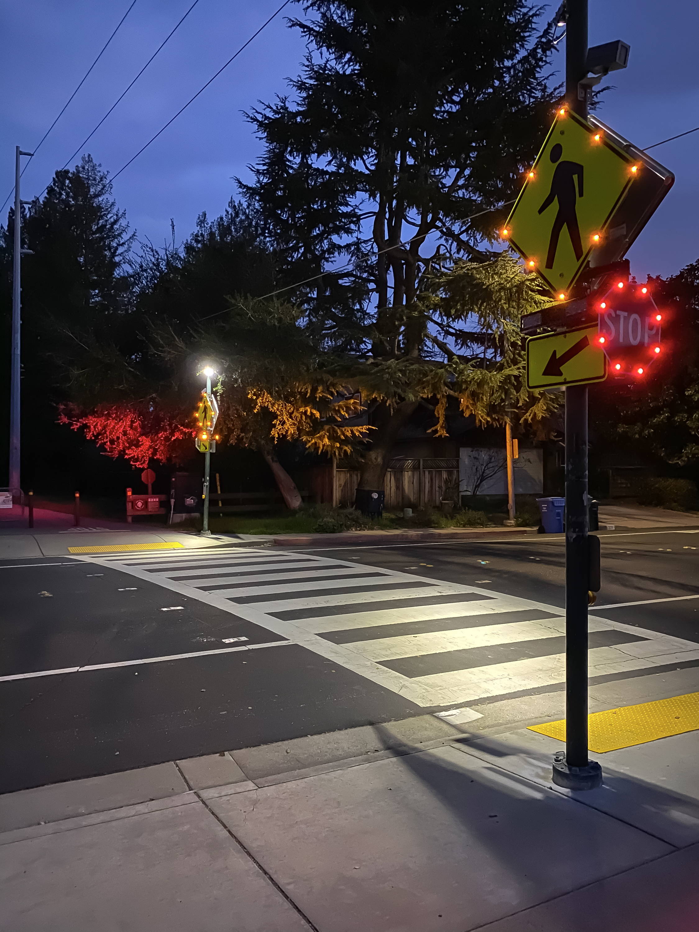 An activated flashing crosswalk sign.
