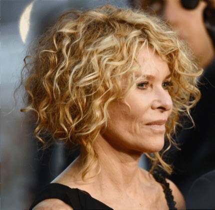 Woman with sandy blonde short cropped hair