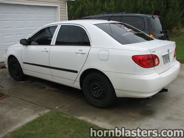 Rear three-quarter white Toyota Corolla driveway garage door Nathan AirChime K5LA train horn gallery photo 2
