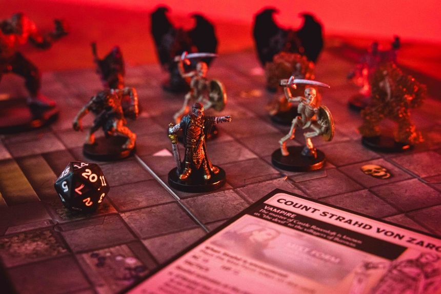 Tabletop game setup with miniature figures and a game card.