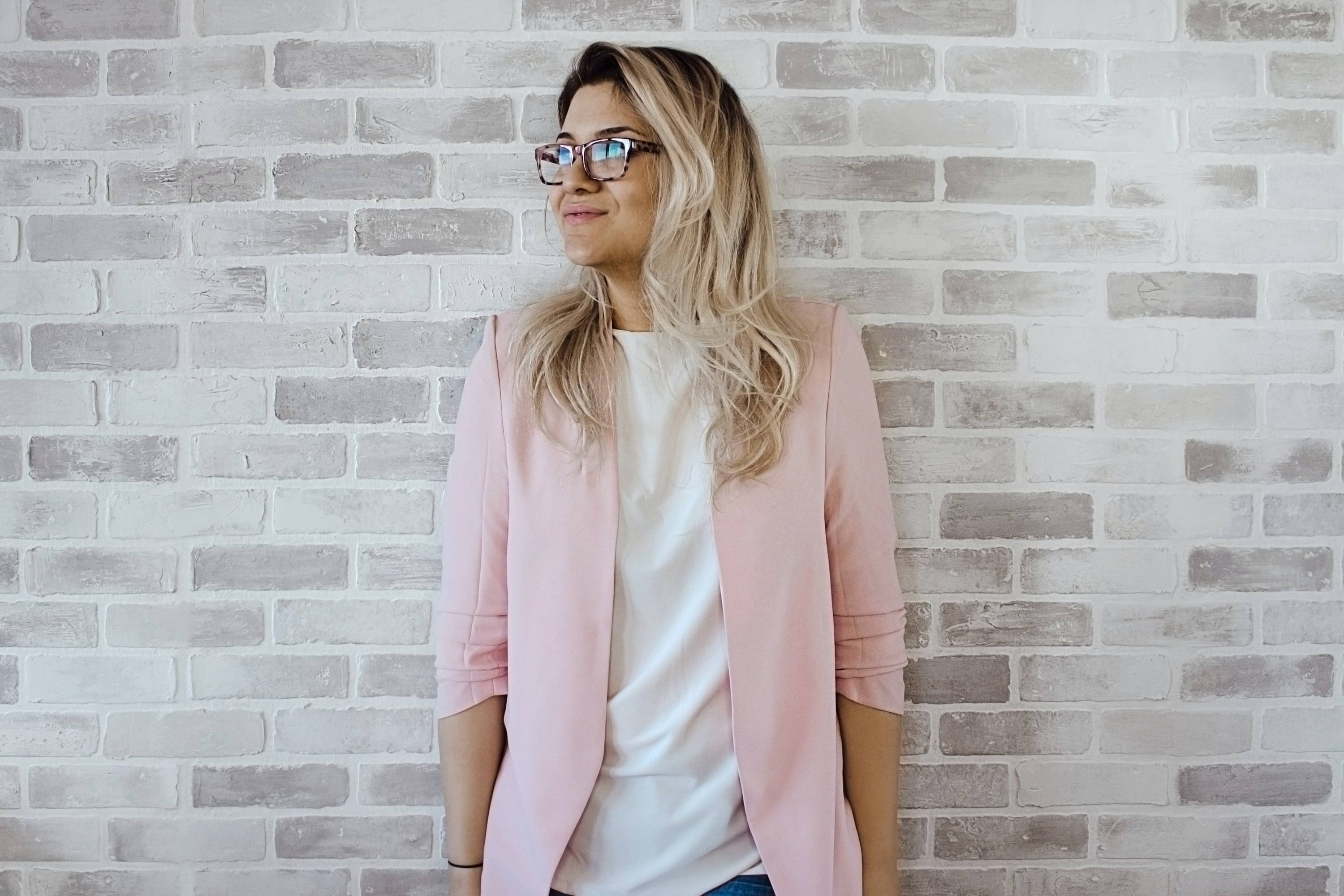 Photo of professional working mom with pink blazer and glasses