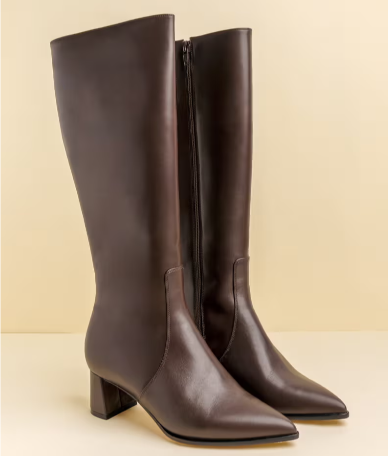 Brown knee-high leather boots with a pointed toe and block heel.