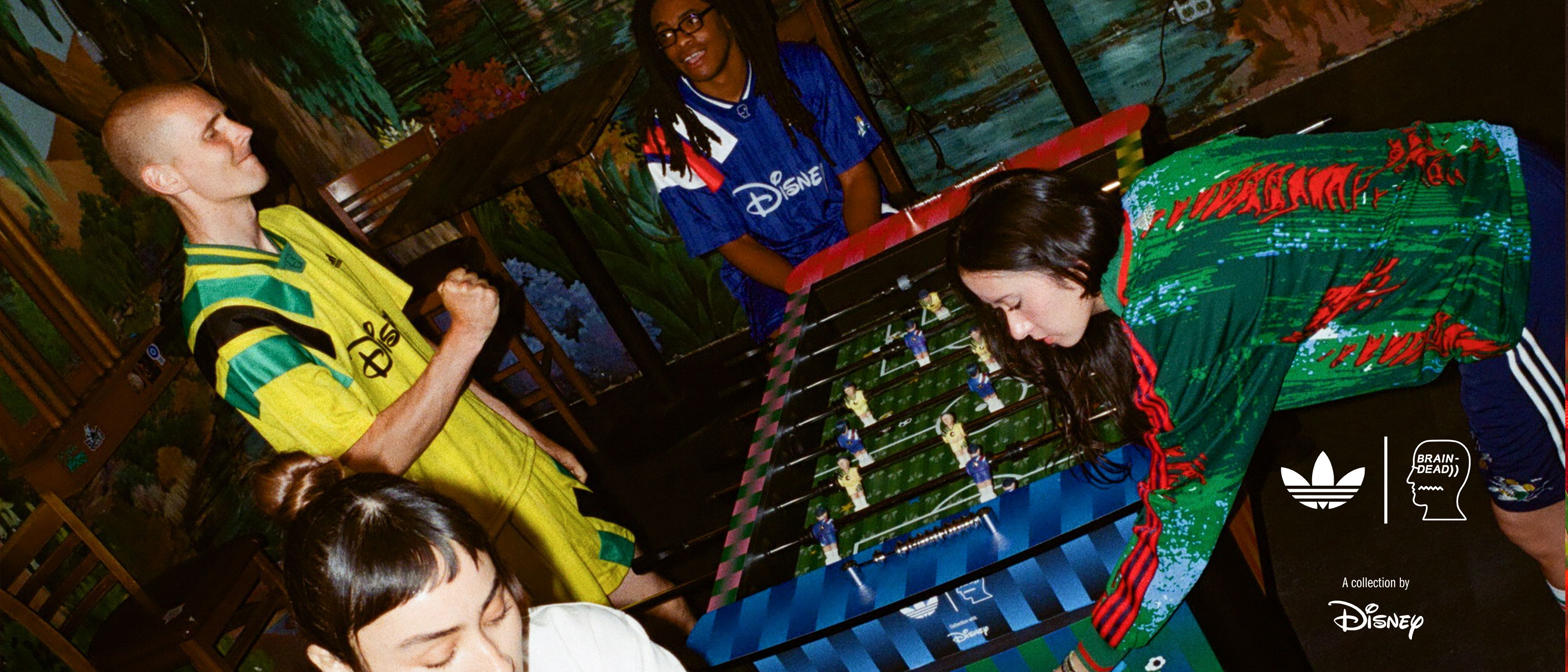 Group of people around a table with bottles in a vibrant setting.