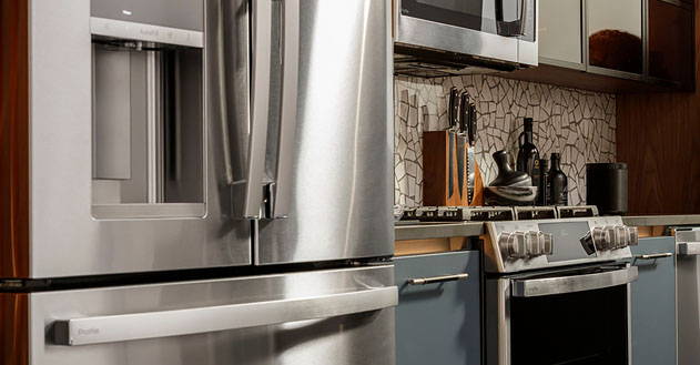 Stainless steel kitchen scene featuring refrigerator, dishwasher and double wall oven