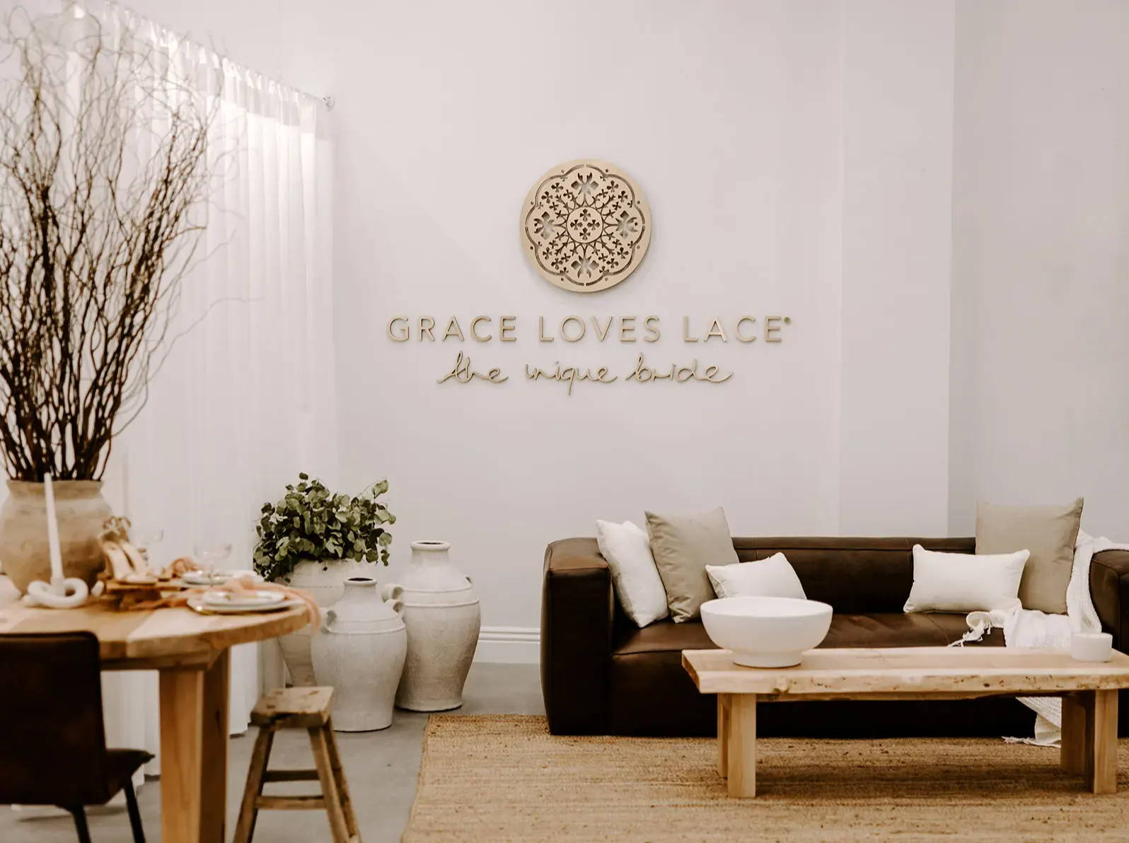 Grace Loves Lace Boutique with coffee table, lounge and large vases