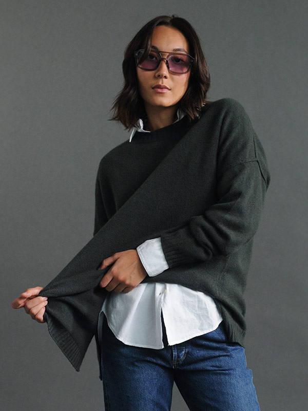 A model wearing a lightweight Jumper 1234 cashmere knitted jumper over a shirt.