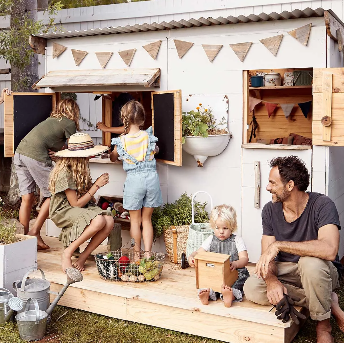 A flat roof cubby house with a family