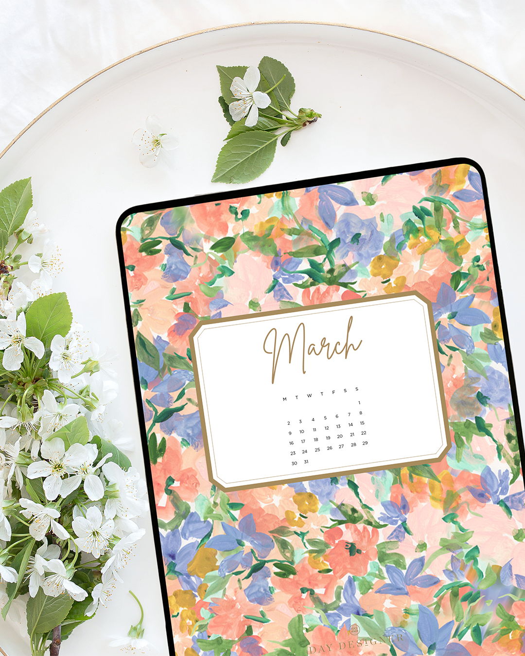 pretty assorted flowers with day designer march calendar shown on a tablet, white plate, white flowers with green leaves