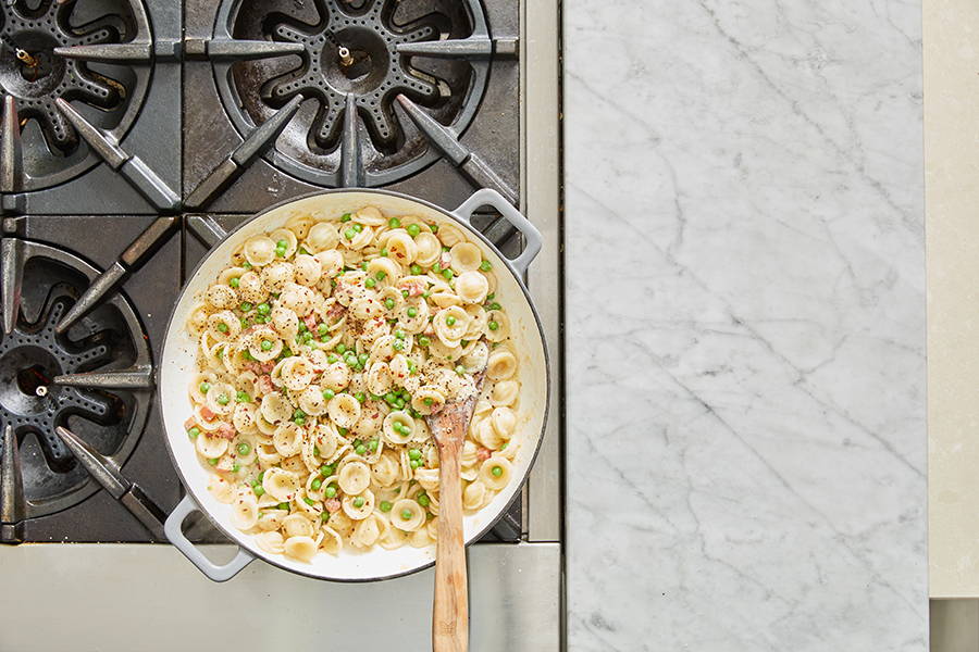 Orecchiette pasta in a creamy sauce with peas and pancetta.