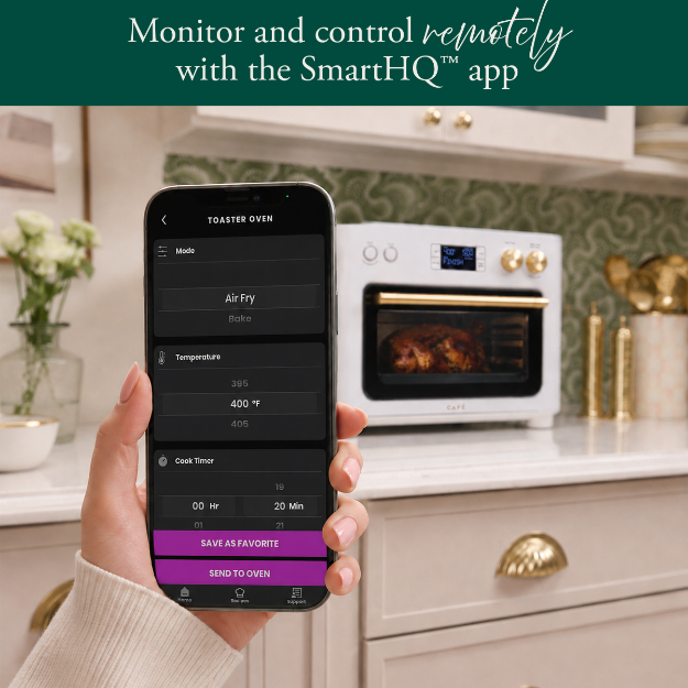 Hand holding smartphone displaying SmartHQ app near an oven in a kitchen.