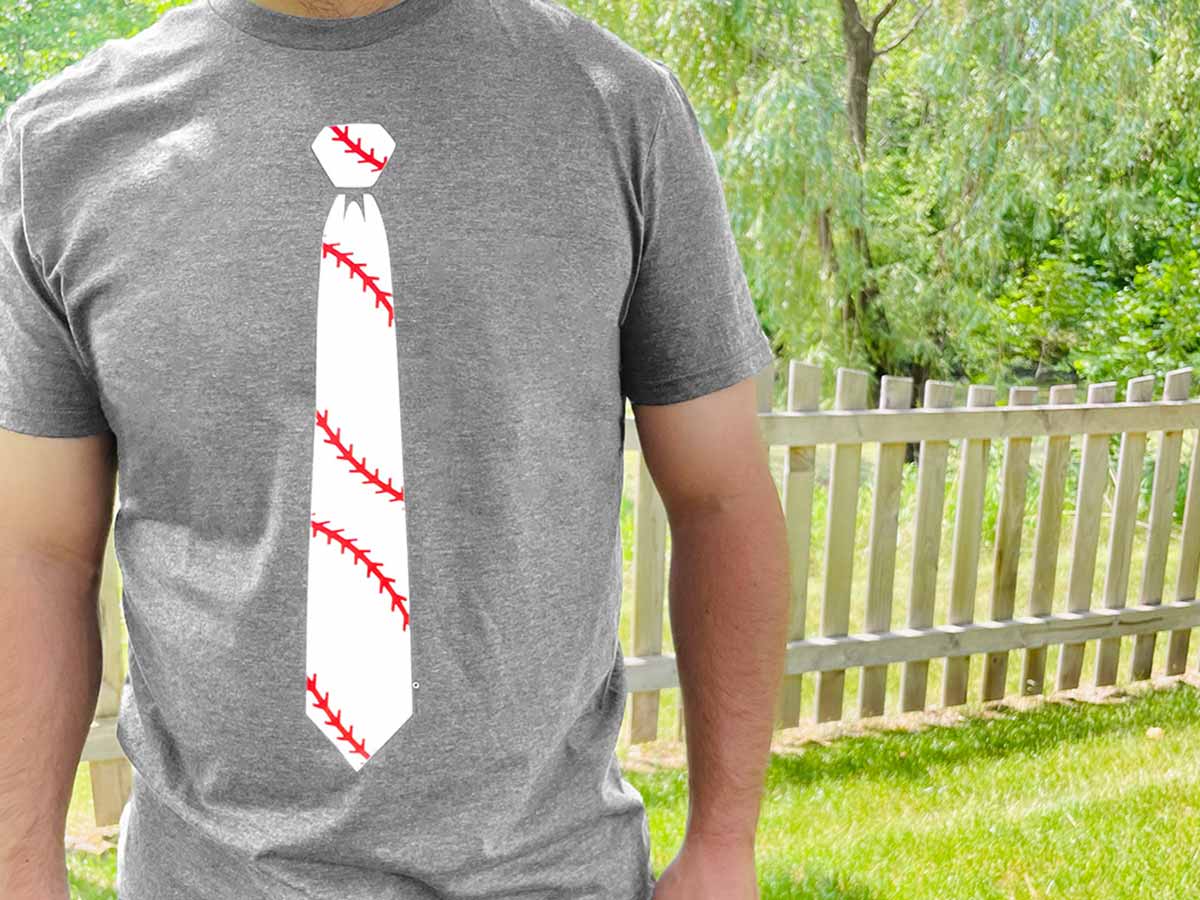 Man wearing a casual baseball-themed necktie t-shirt outdoors on a sunny summer day.