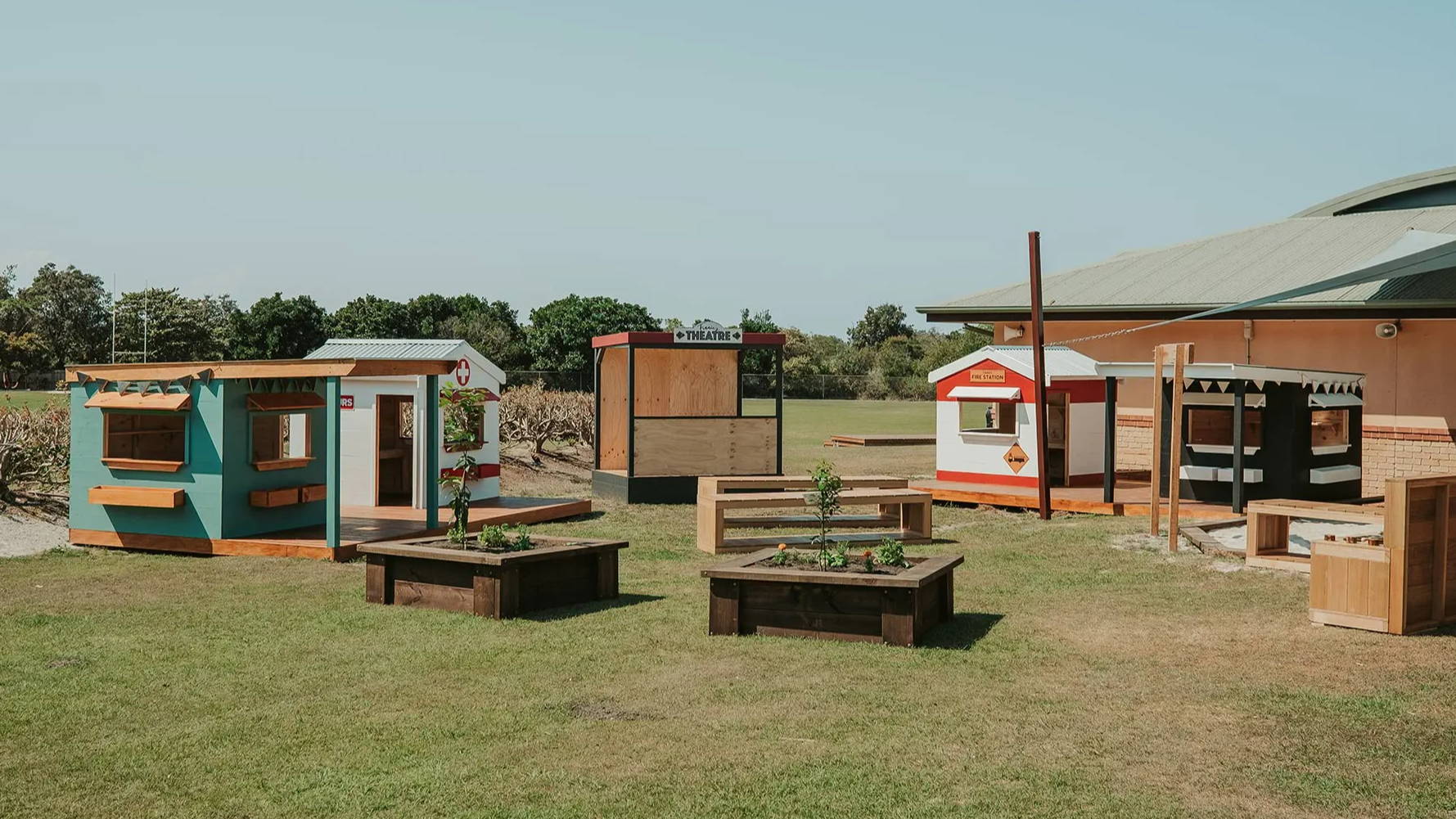 A play based learning village with cubby houses, garden beds and a mud kitchen at St Finbar's Primary School