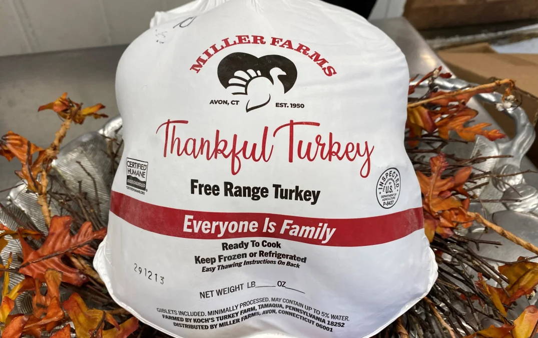 Miller Farms Thankful Turkey in white bag on top of leaves.