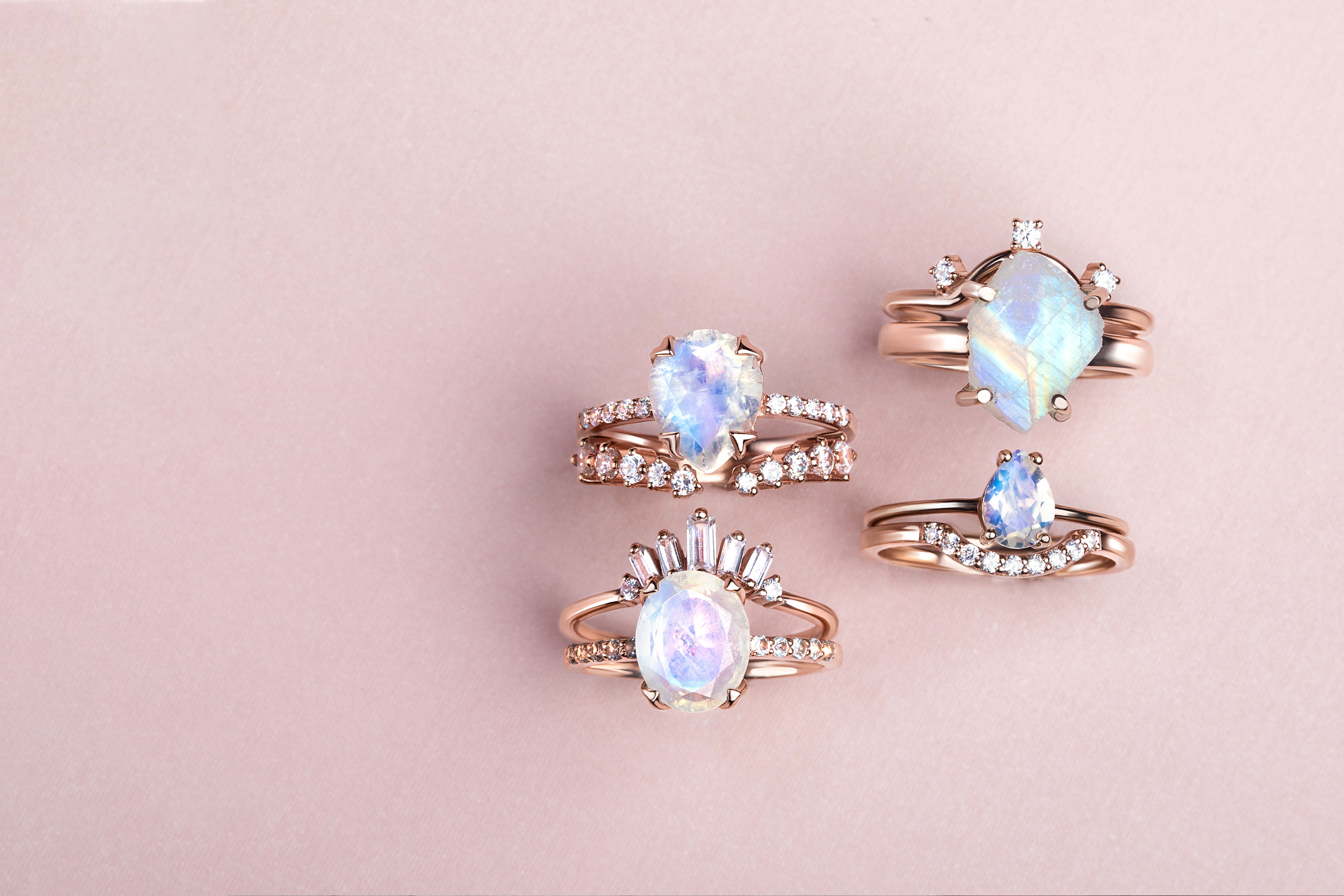Four Moonstone rings combined with band rings in different styles are presented.