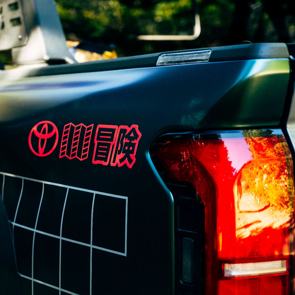 Close-up of a Toyota vehicle's rear with logo and text.