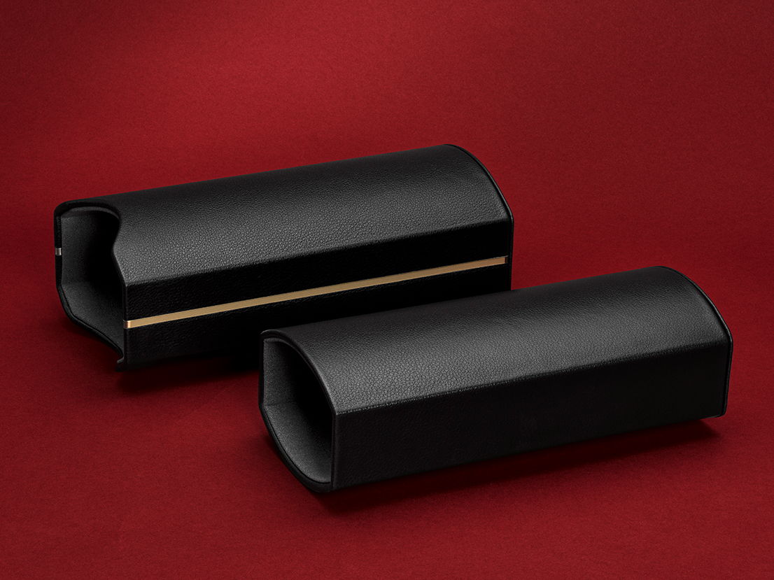 Two black cylindrical objects on a red background.