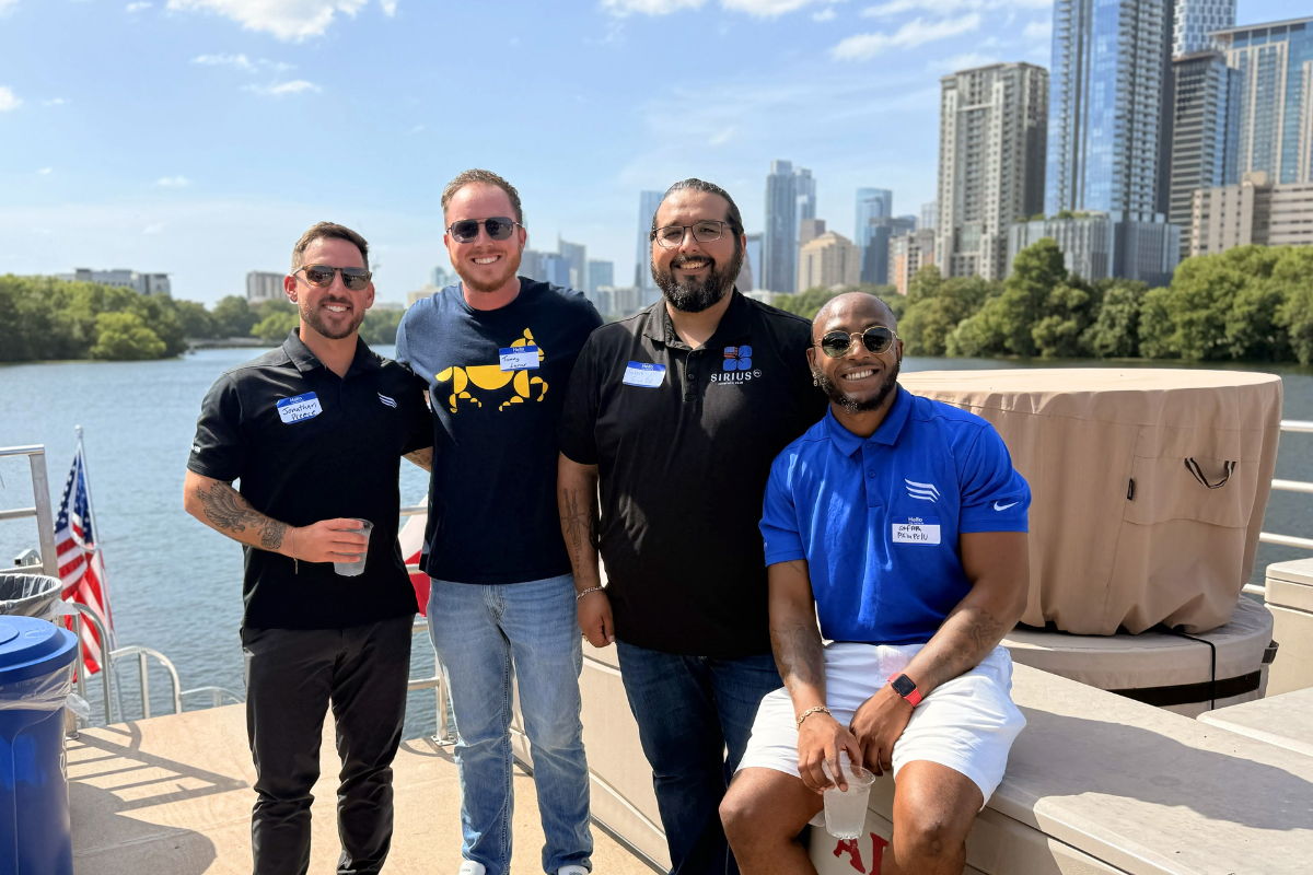 Solar vendors on boat smiling in front of Austin skyline
