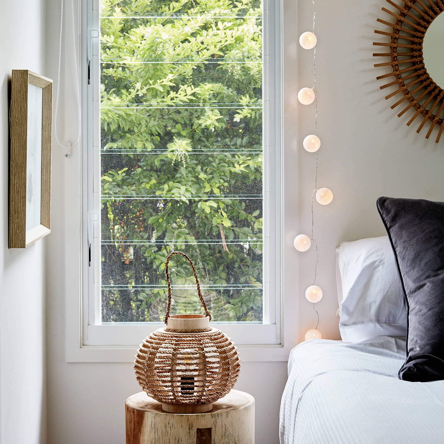 Cotton ball fairy lights hanging from the wall in a bedroom.