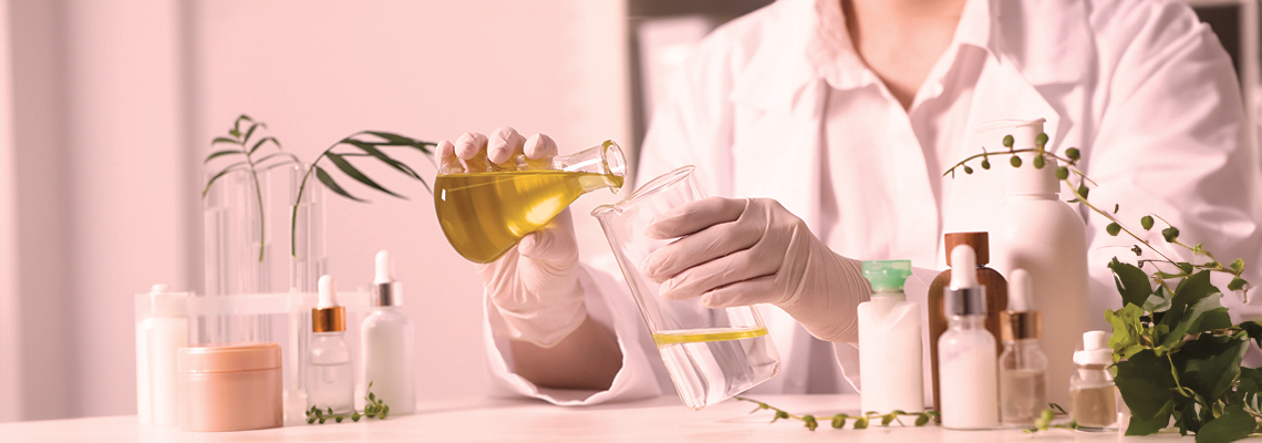 Scientist in a lab pouring liquid into a beaker with plants around.