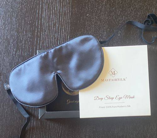 black sleep eye mask resting on gift box