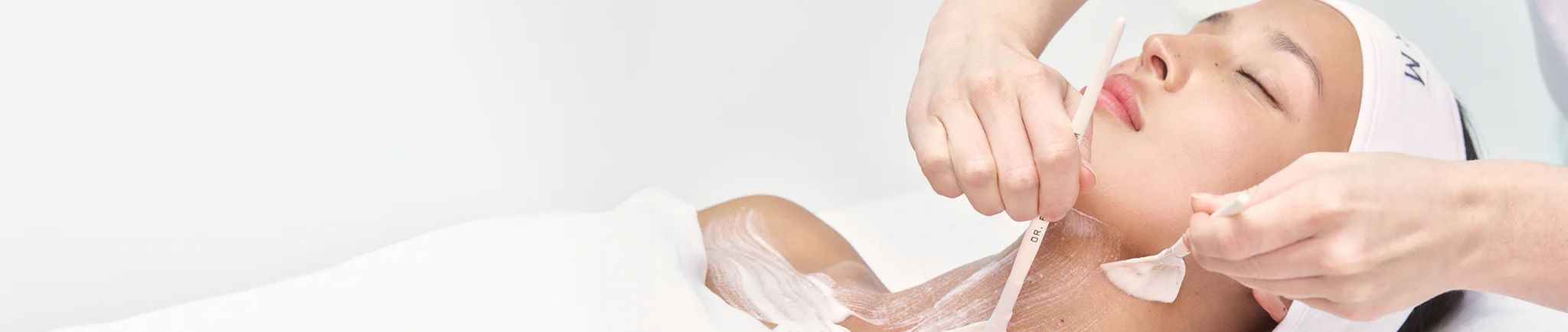 Person receiving a facial treatment in a spa environment.