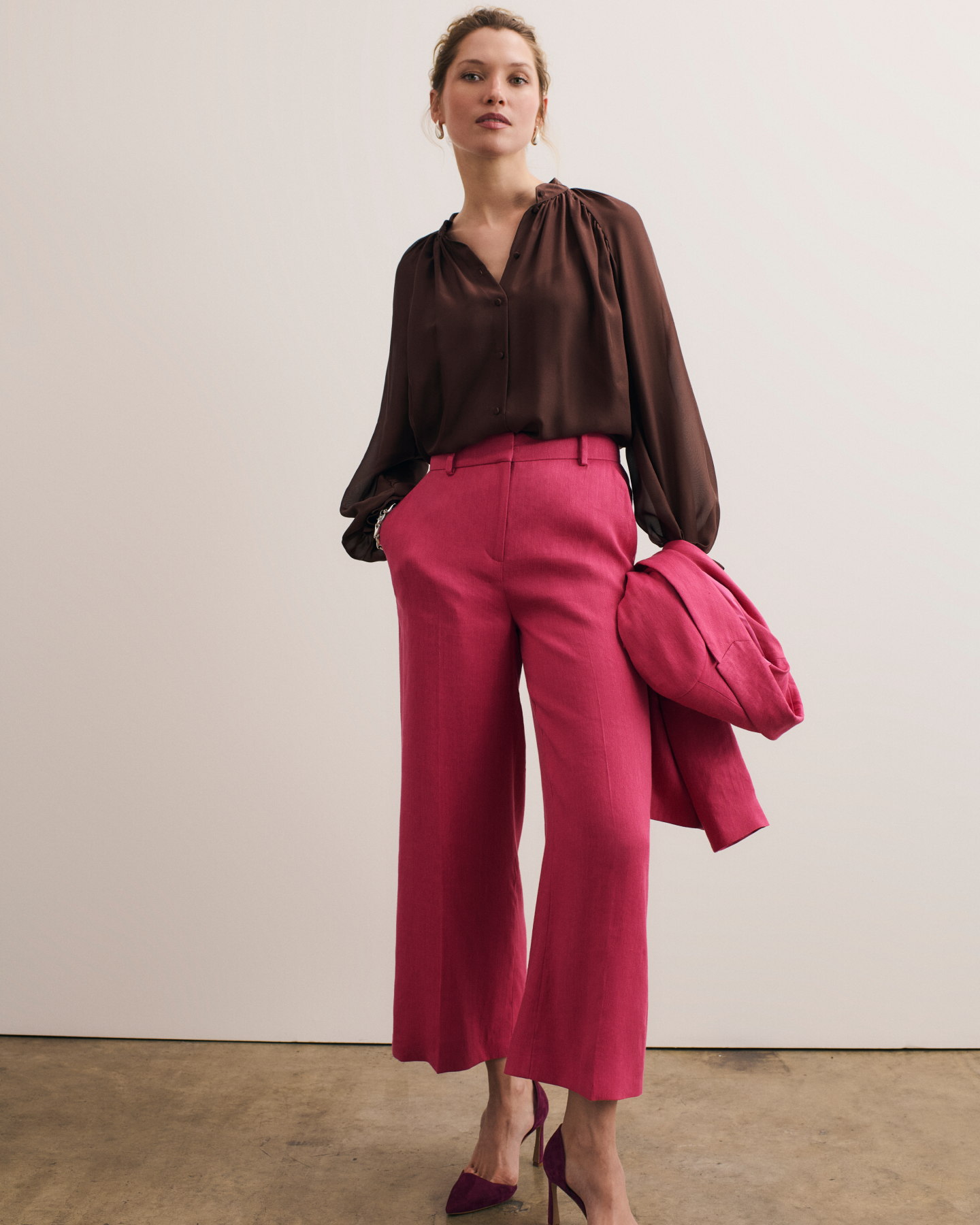 Model wearing fuchsia Assisi trousers and chocolate Riola blouse