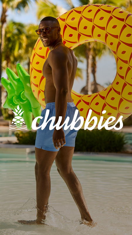 Man in swim shorts walking in pool with inflatable pineapple.