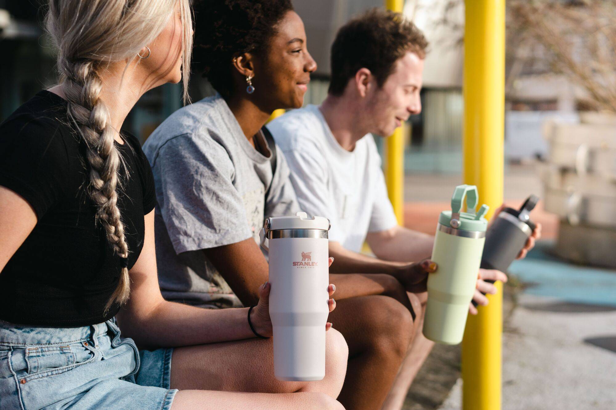 College students talking and drinking from Stanley Travel Tumblers