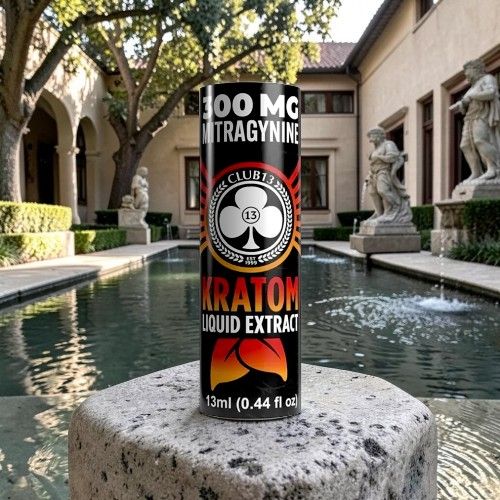 Kratom liquid extract canister placed near a fountain in a garden setting.