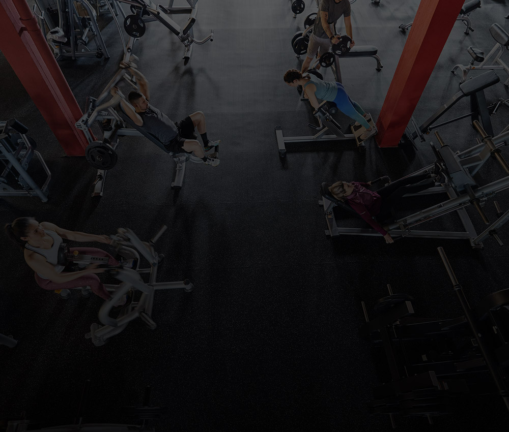 People exercising in a gym with workout equipment, representing security and monitoring solutions for health and fitness centres