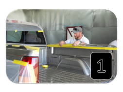 technician masking truck bed for spray on bedliner