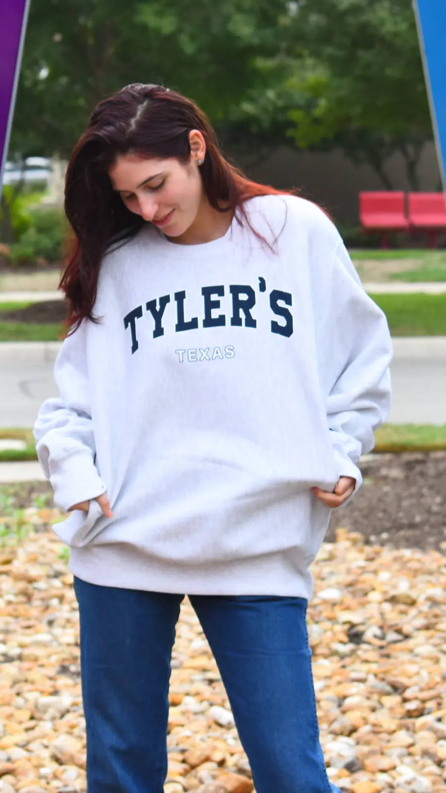 Young woman wearing a TYLER'S sweatshirt in the park