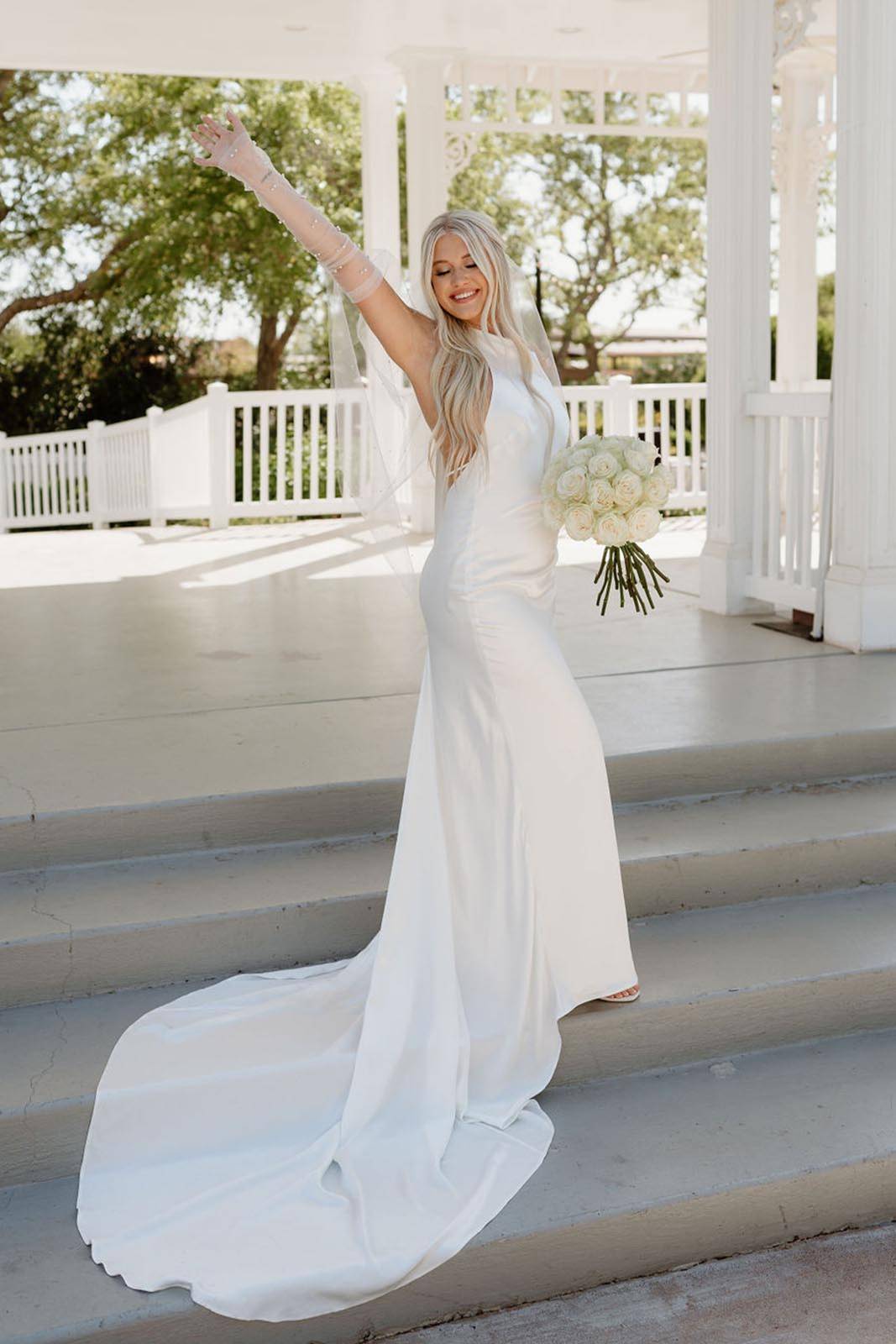 Bride, joyfully showing her wedding dress 