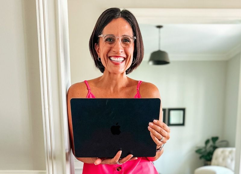 woman wearing Grace clear blue light blocking glasses while working on laptop