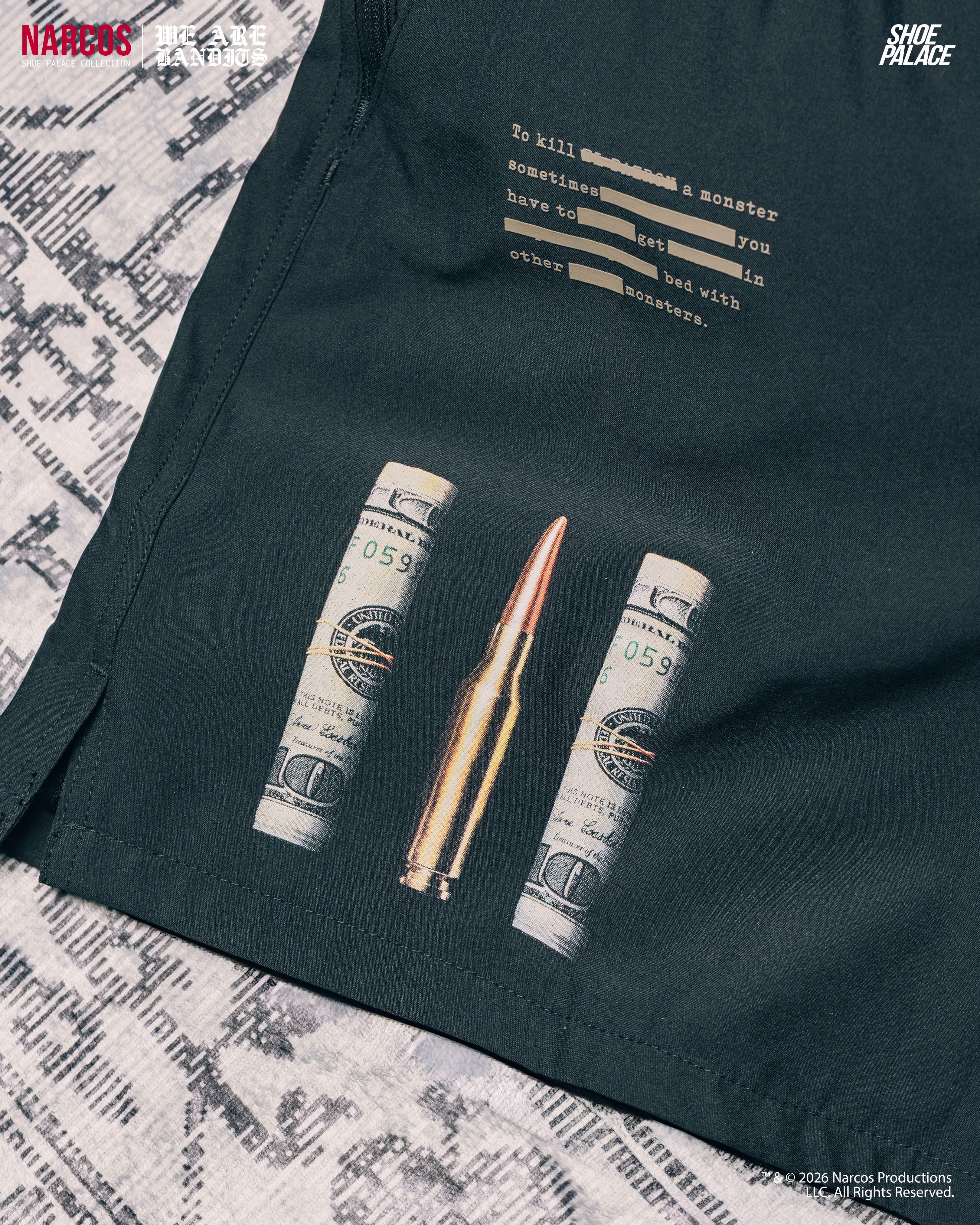 Graphic design featuring a bullet and two rolled dollar bills on fabric.