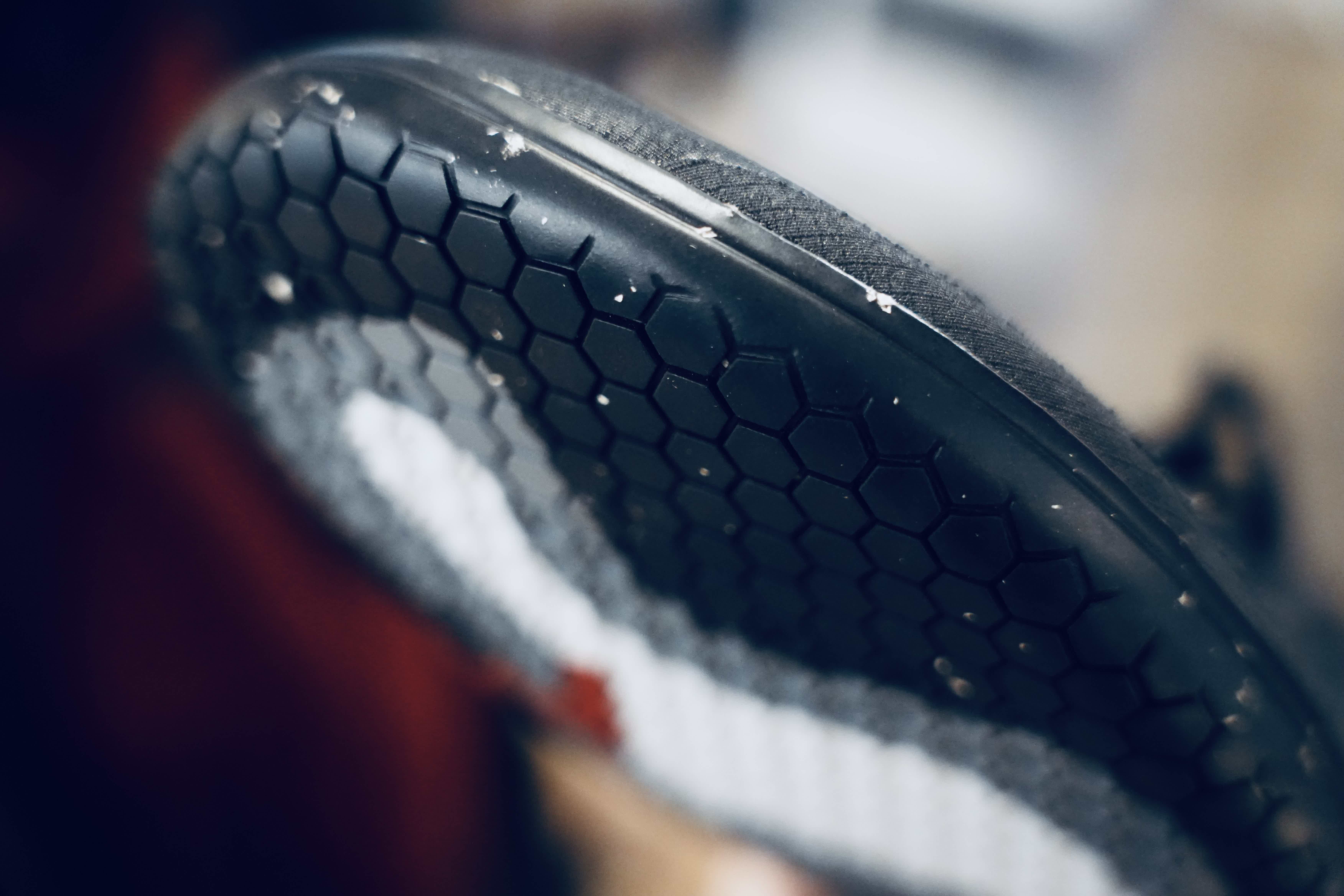 Close-up of a shoe's textured sole with a honeycomb pattern.